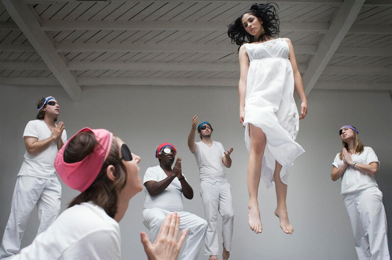 woman levitating above group