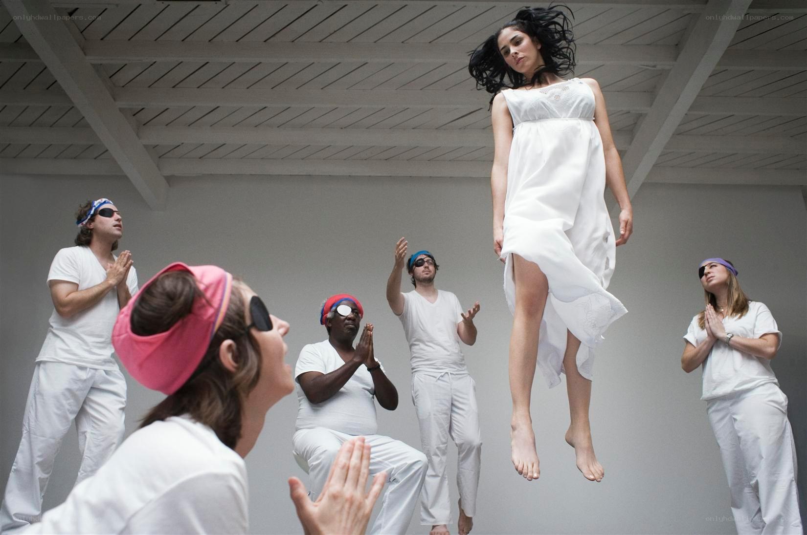 woman levitating above group
