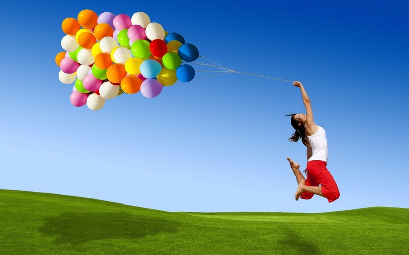woman lifted by balloons
