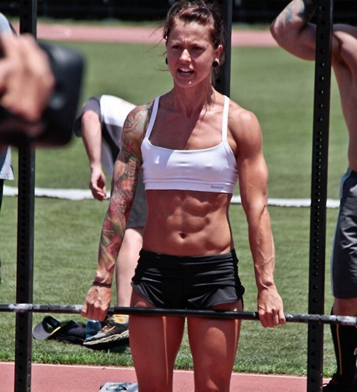 woman lifting barbell at crossfit event