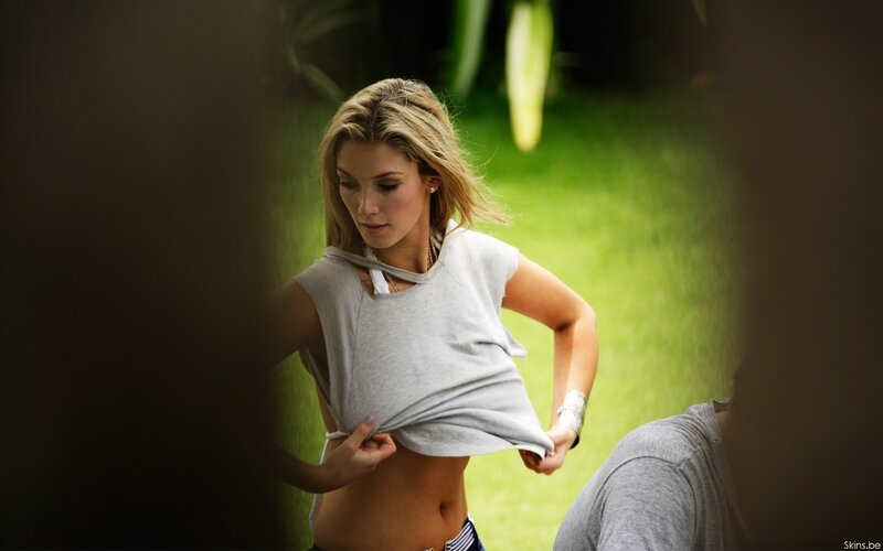 woman lifting shirt outdoors