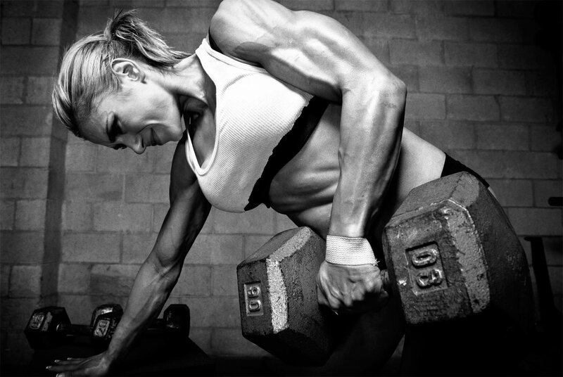 woman lifting weights in gym