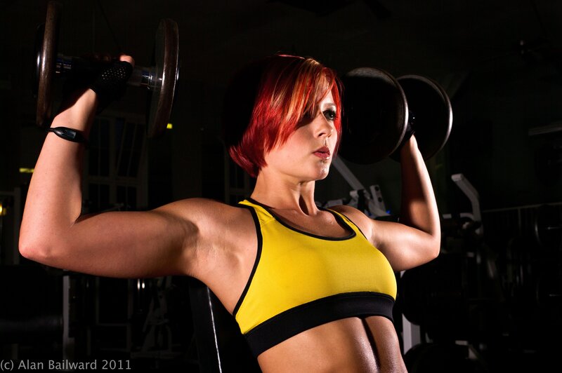 woman lifting weights in gym