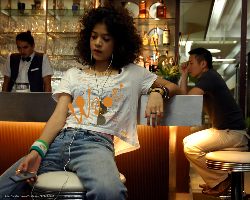 Woman listening to music at bar