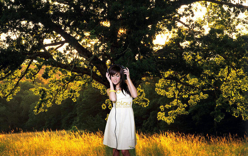 Woman listening to music in a field