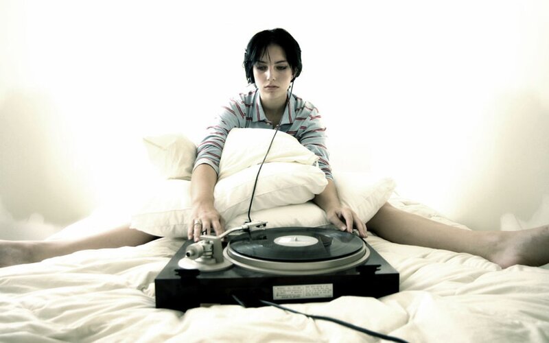 woman listening to music in bed