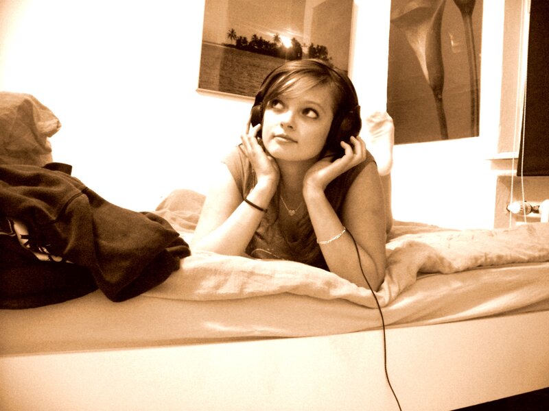 woman listening to music in bed