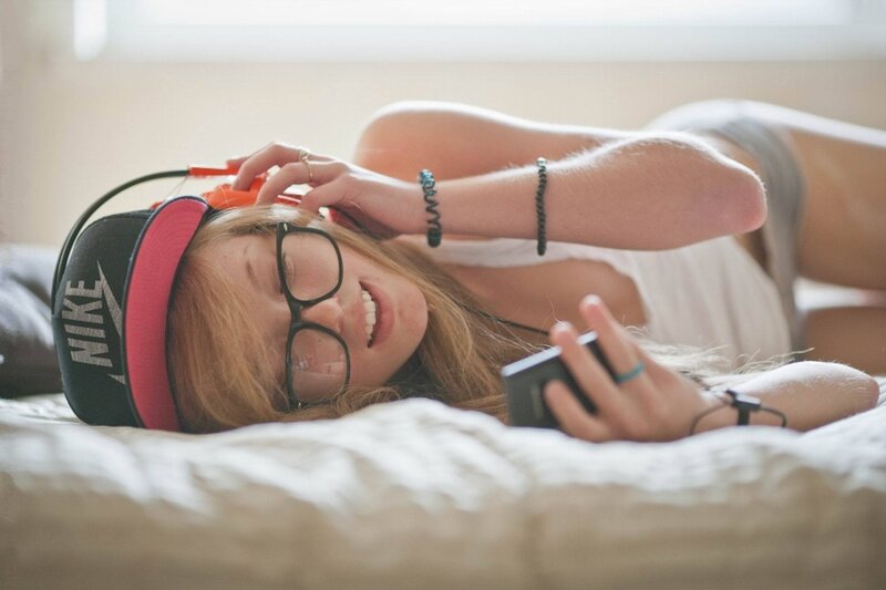 woman listening to music in bed