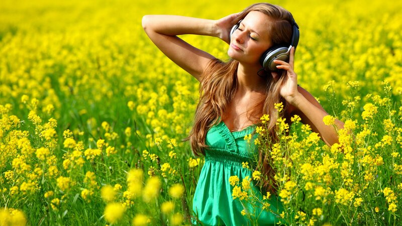 woman listening to music in field