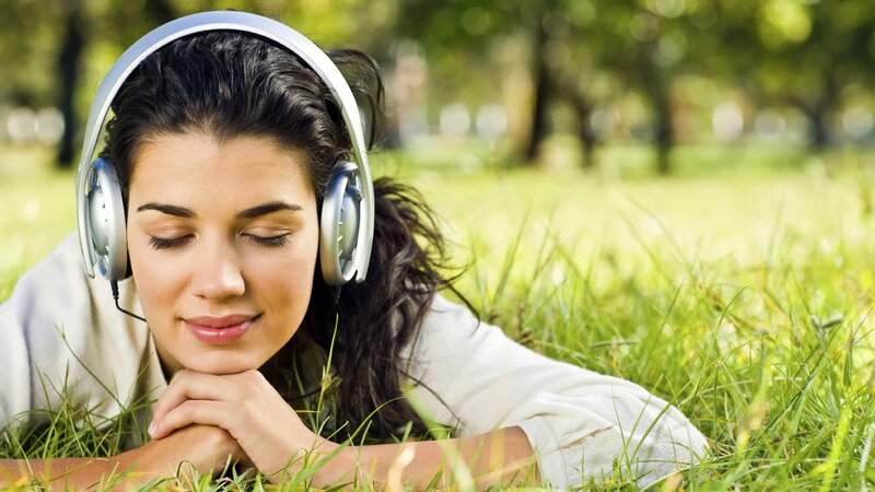 woman listening to music in park