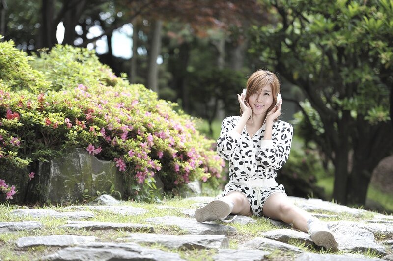 Woman listening to music in park