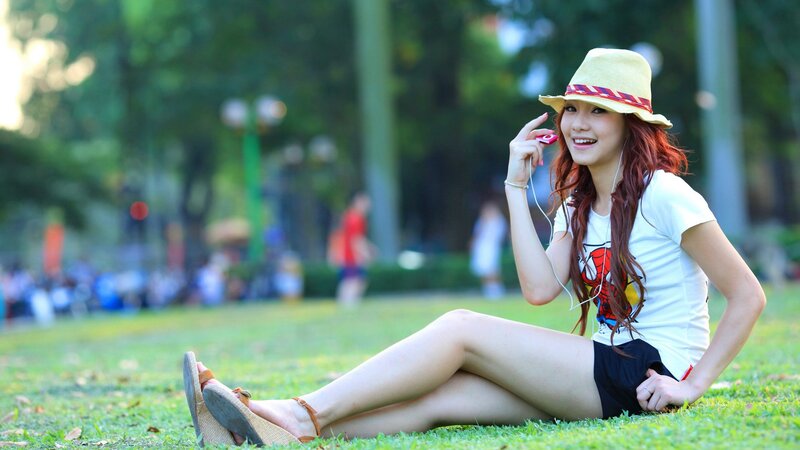 Woman listening to music in park