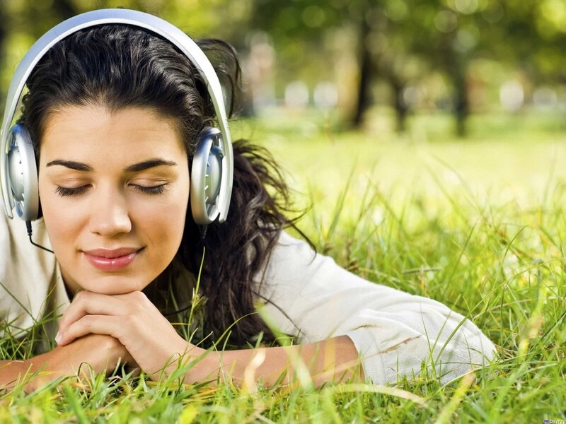 Woman listening to music in park