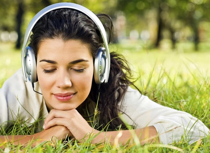 woman listening to music in park