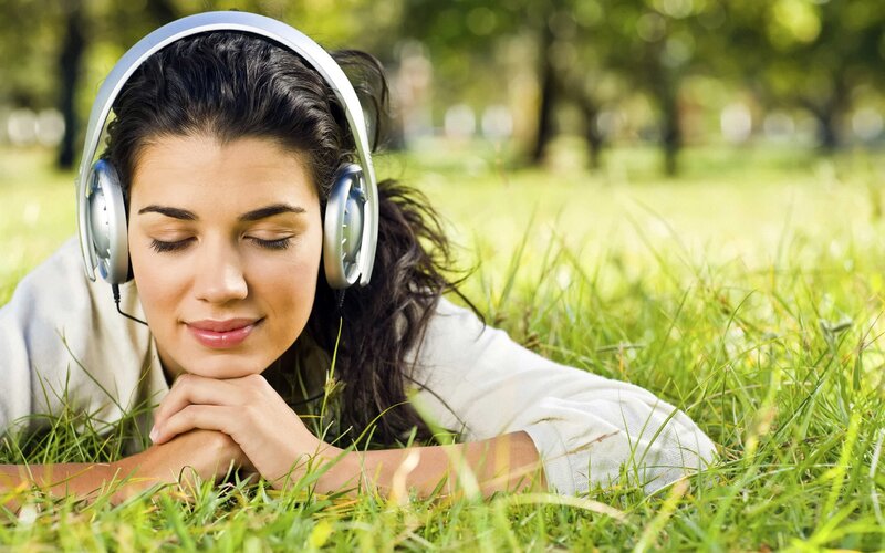 woman listening to music in park