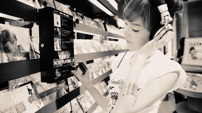 woman listening to music in record store