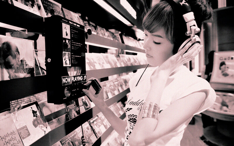 woman listening to music in record store