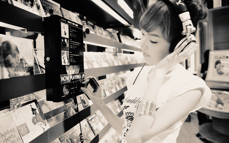 woman listening to music in store