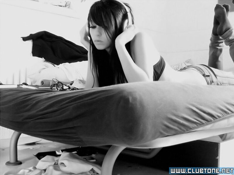 woman listening to music on bed
