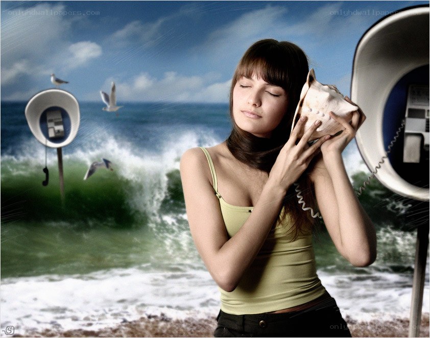woman listening to seashell