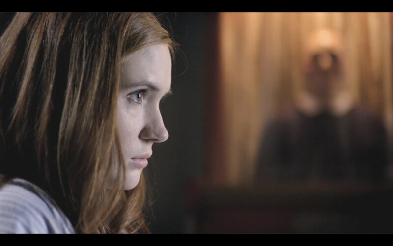 woman looking at blurred figure