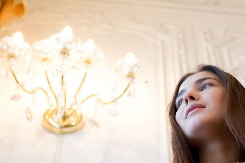 woman looking at chandelier