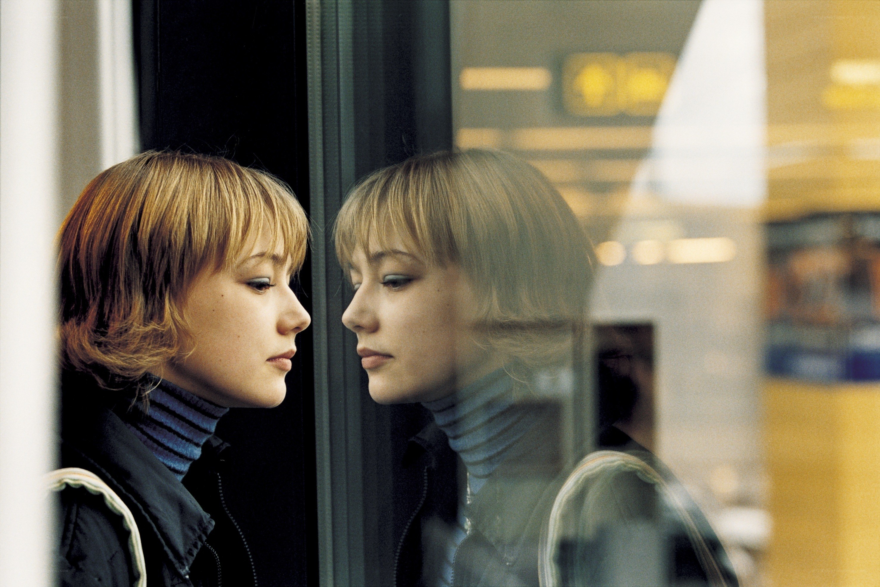woman looking at her reflection