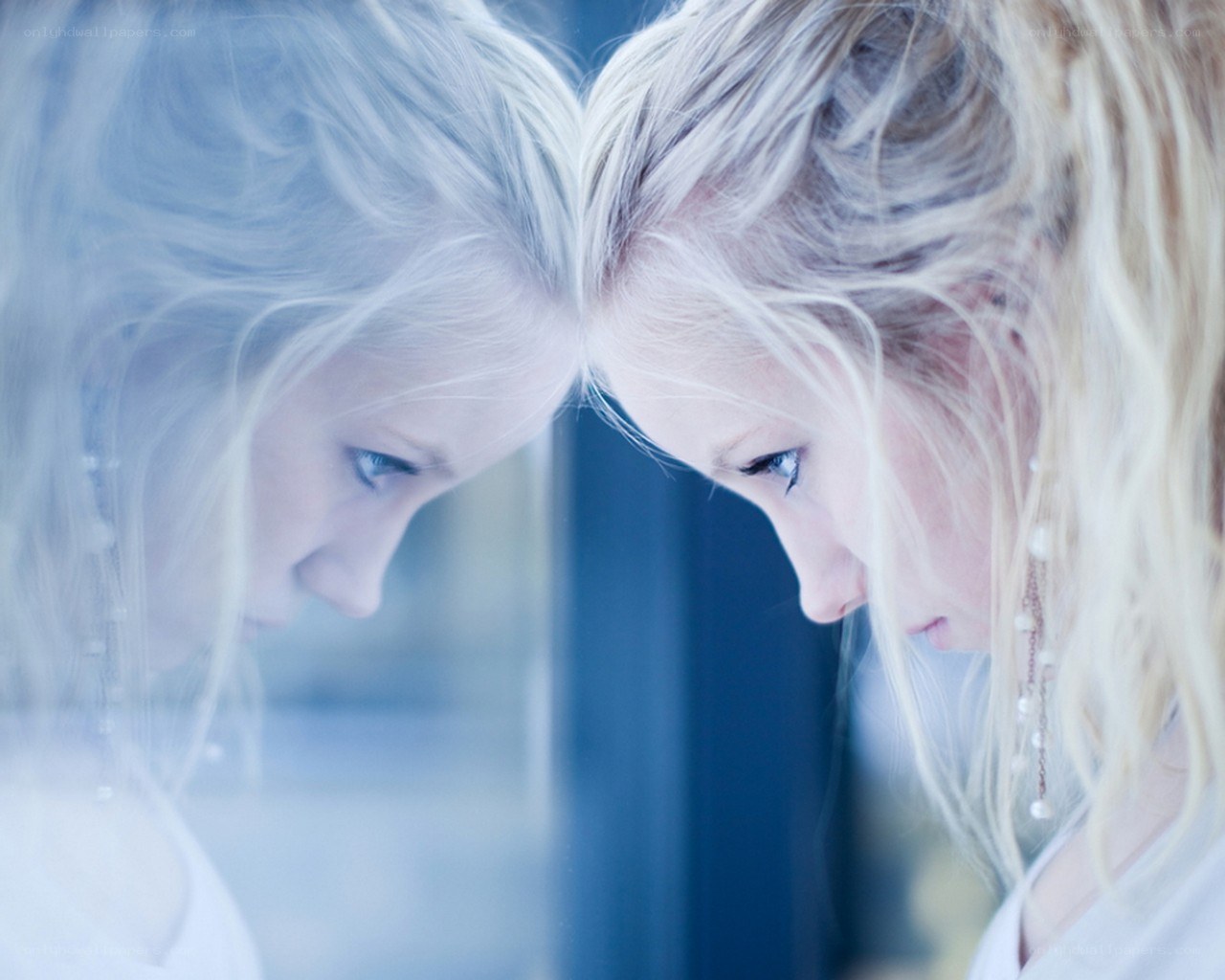 woman looking at her reflection