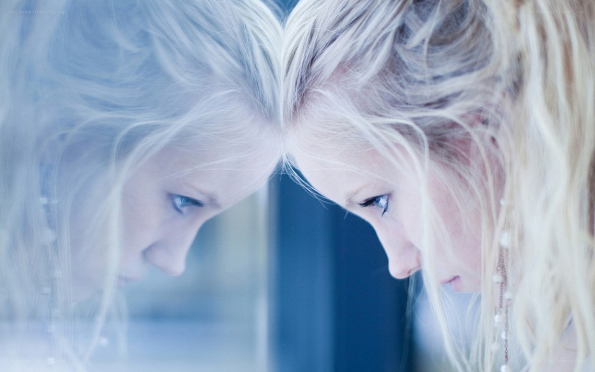 woman looking at her reflection