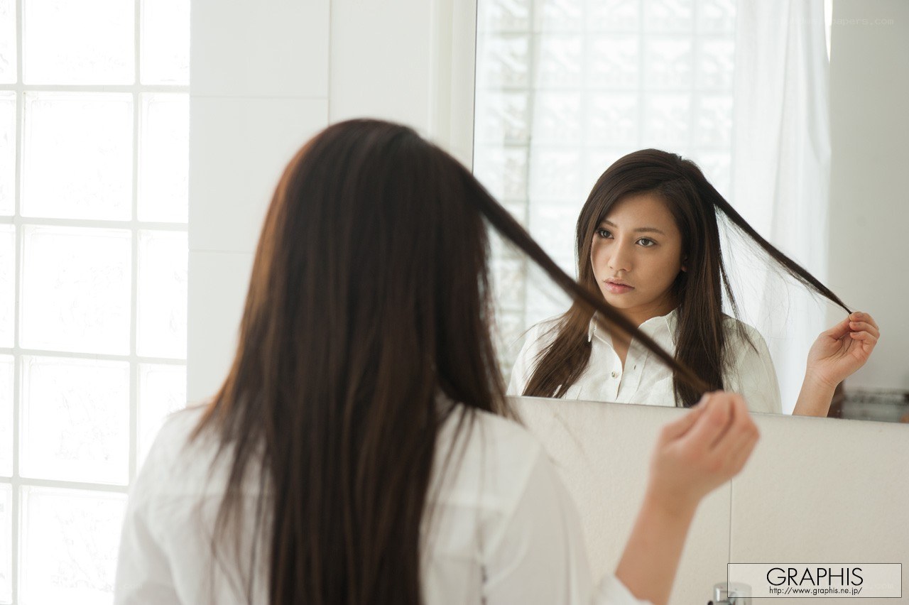 woman looking at her reflection