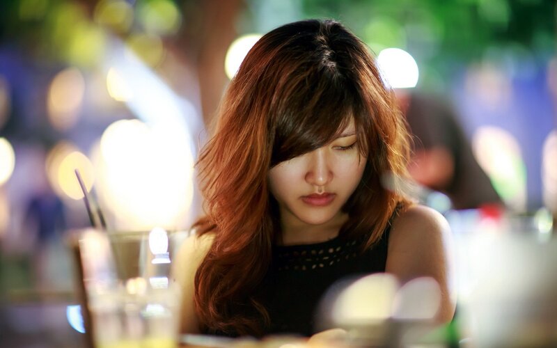woman looking at phone in restaurant