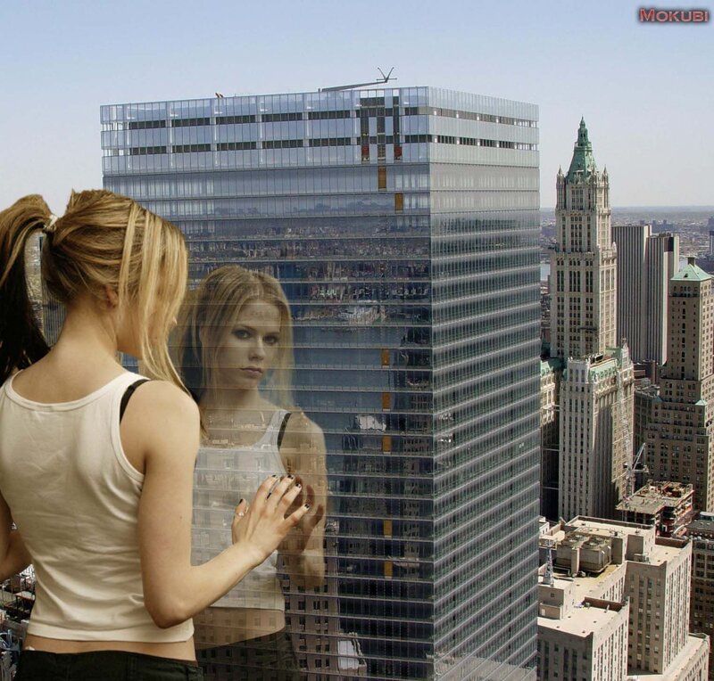 Woman looking at reflection in glass