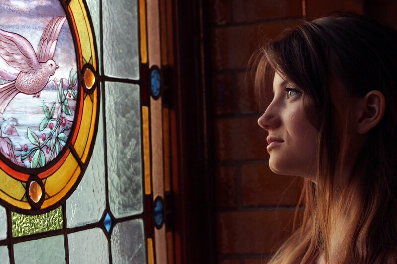 woman looking at stained glass