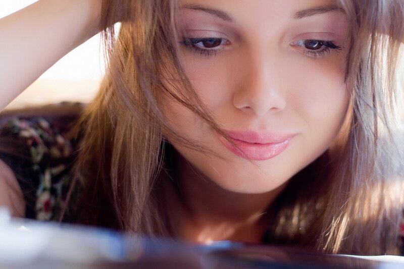 woman looking down at device