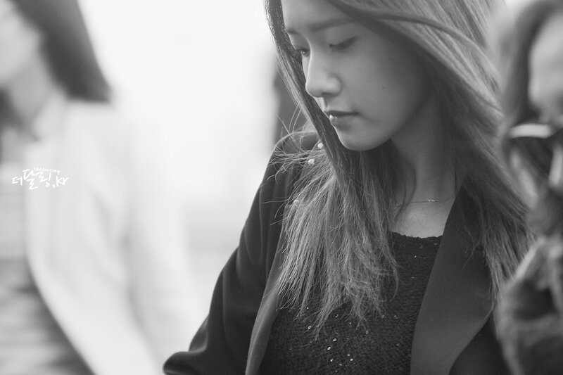 woman looking down in black and white