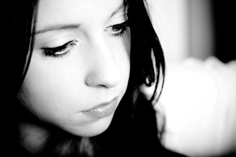 woman looking down in black and white