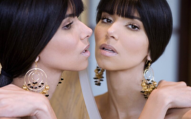 woman looking in mirror