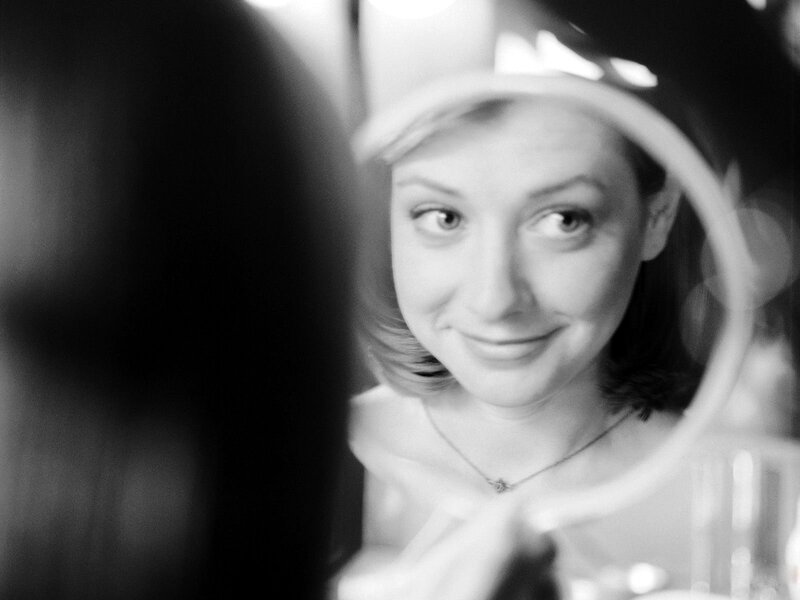 woman looking in mirror