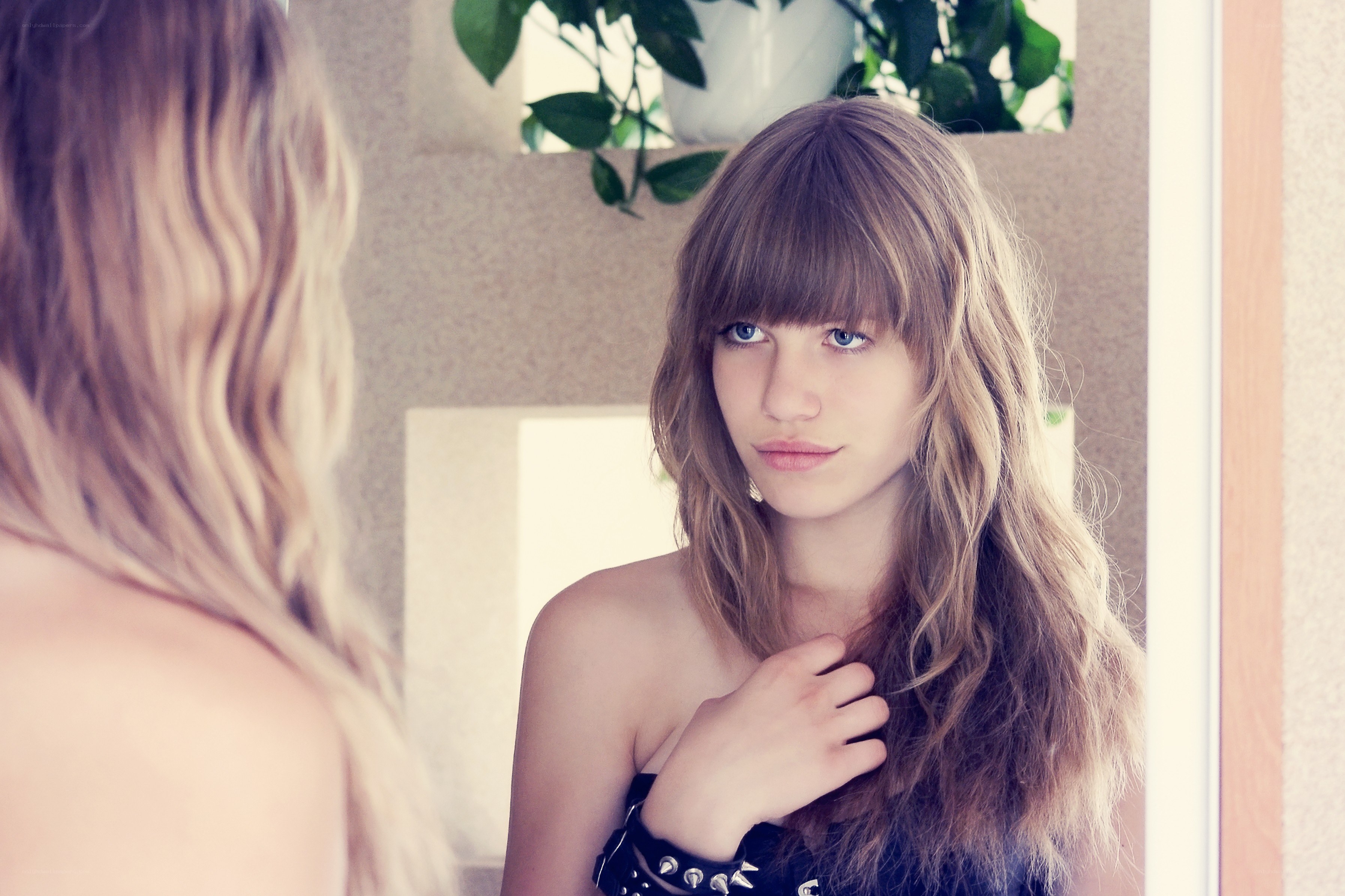 woman looking in mirror