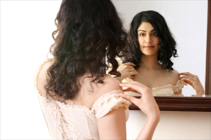 woman looking in mirror