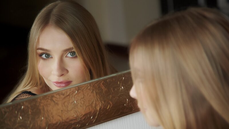 woman looking in mirror