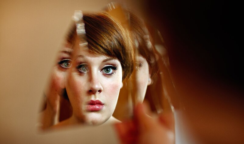 woman looking in mirror