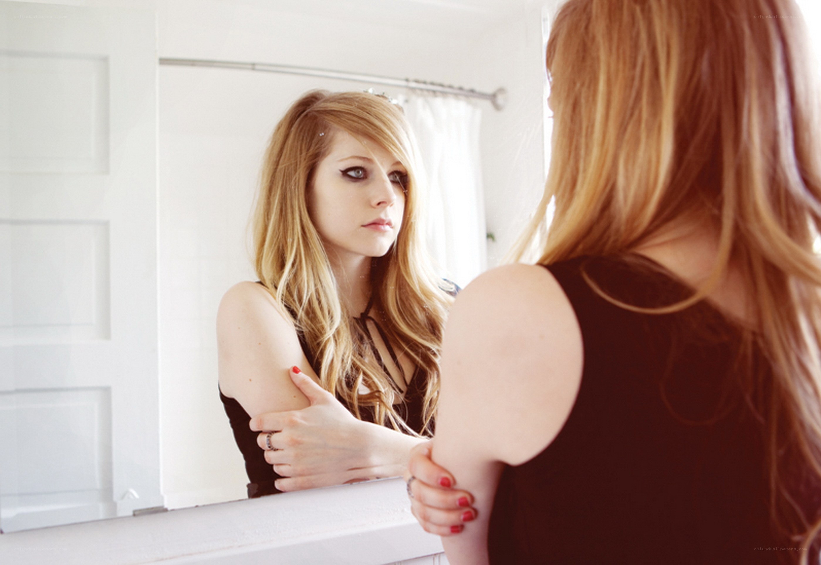 woman looking in mirror