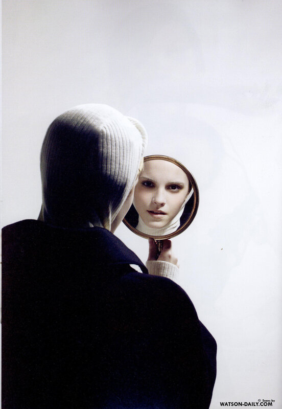 woman looking in mirror