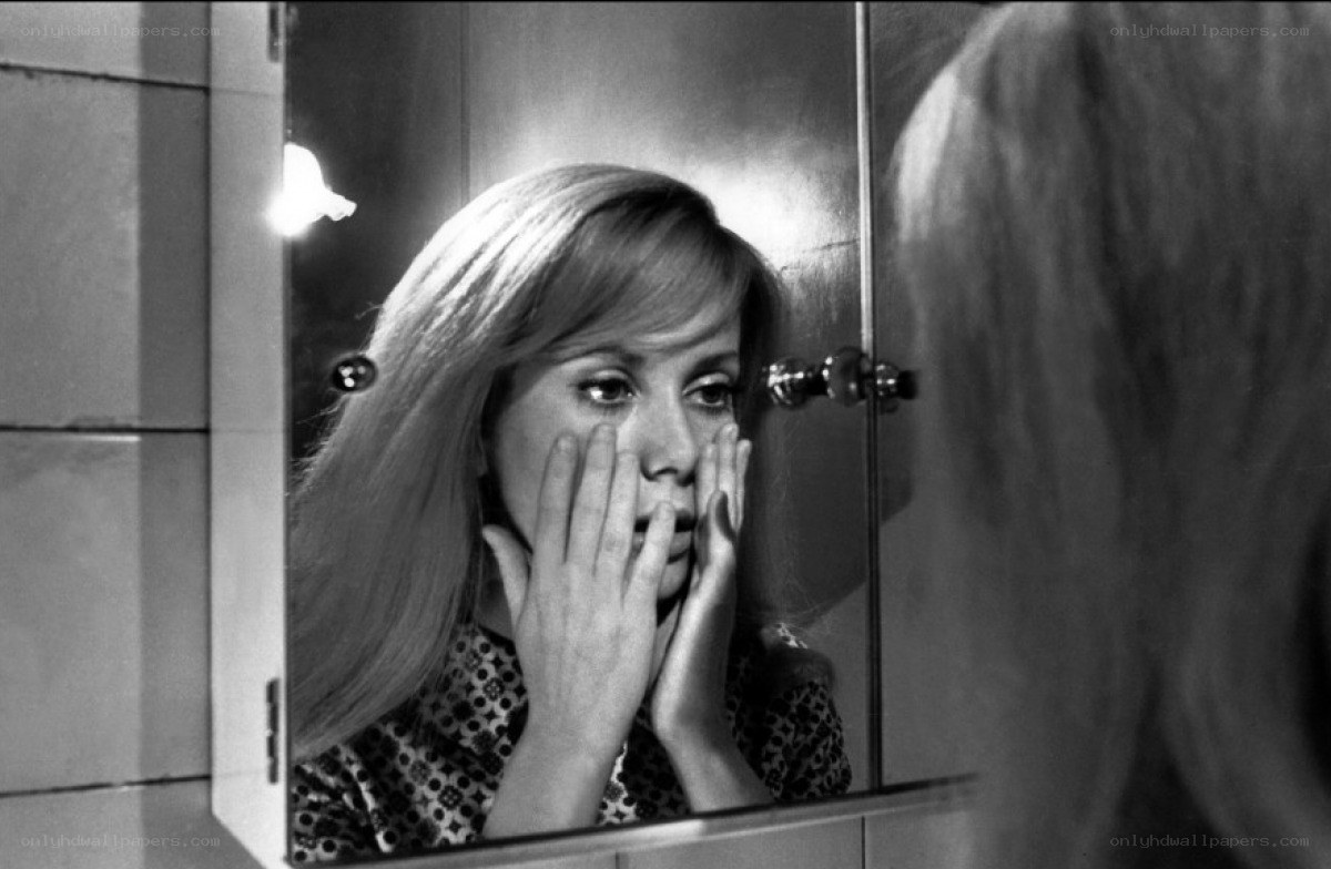 woman looking in mirror