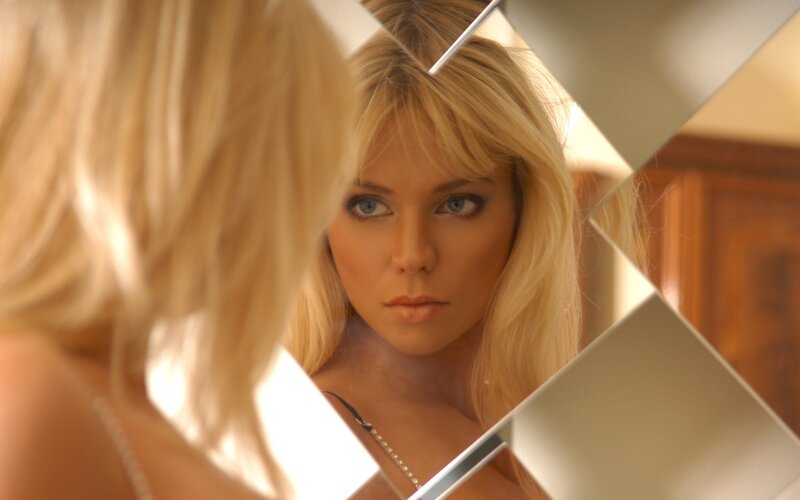 Woman Looking in Mirror — Blonde
