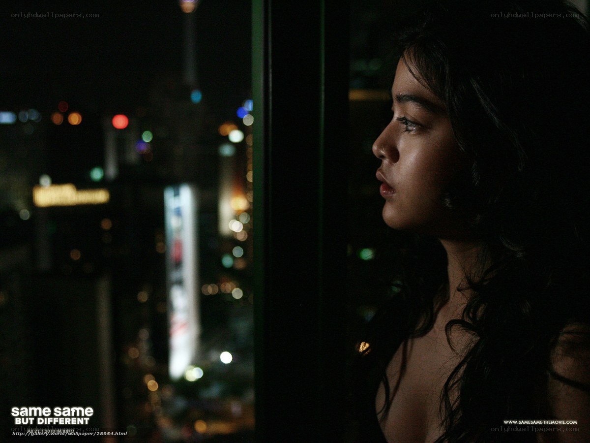 woman looking out at city at night