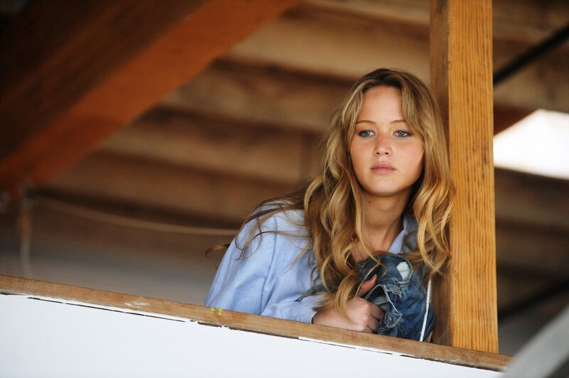 woman looking out from wooden structure