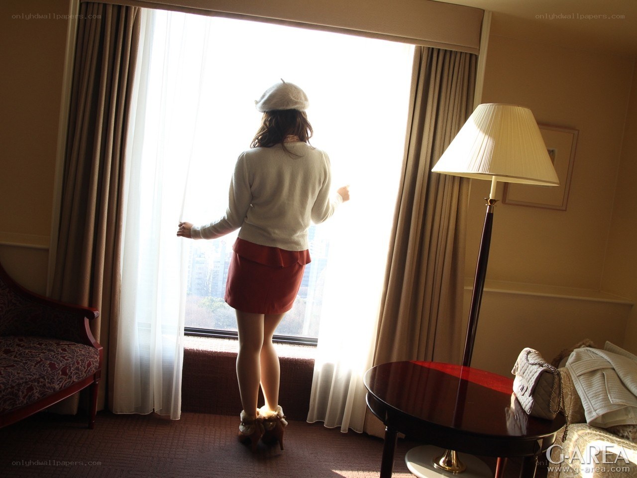Woman looking out hotel window