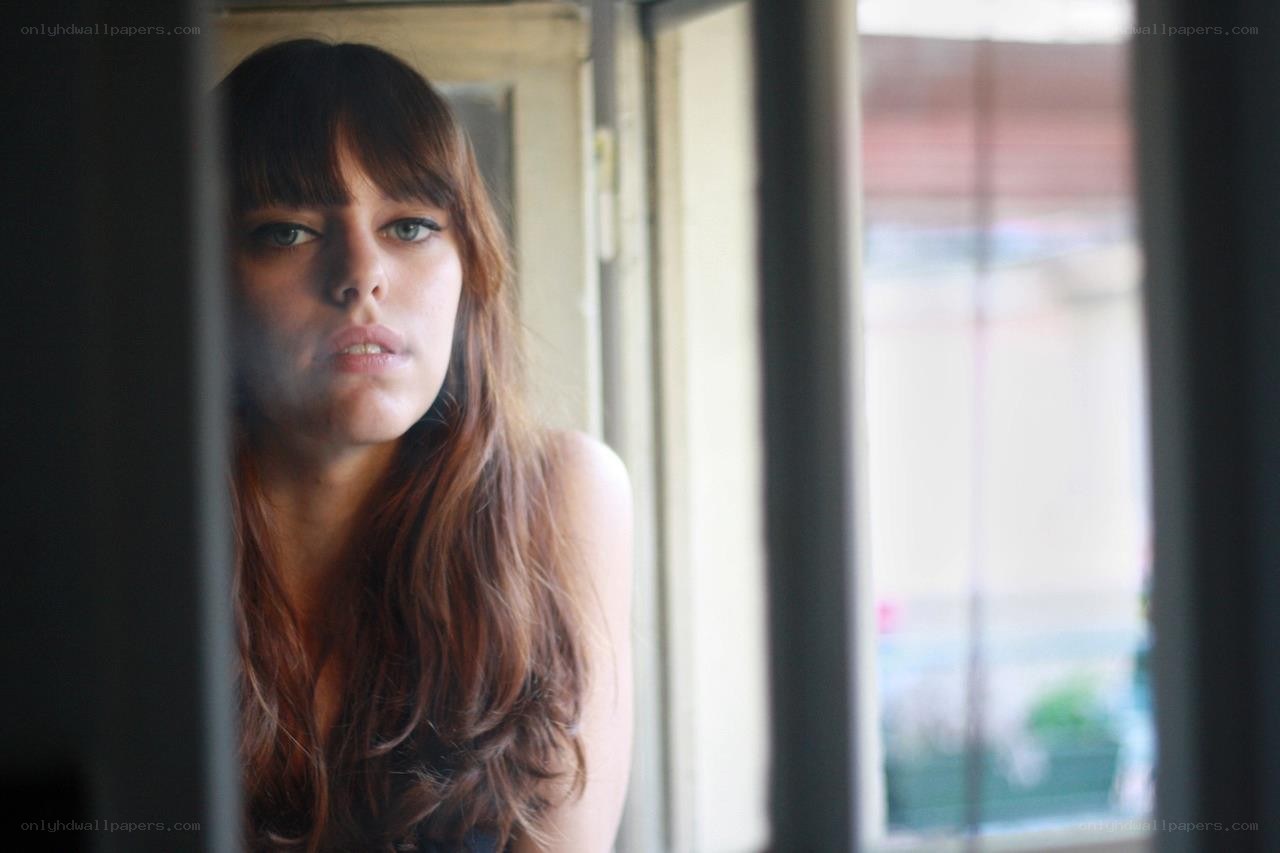 woman looking out window